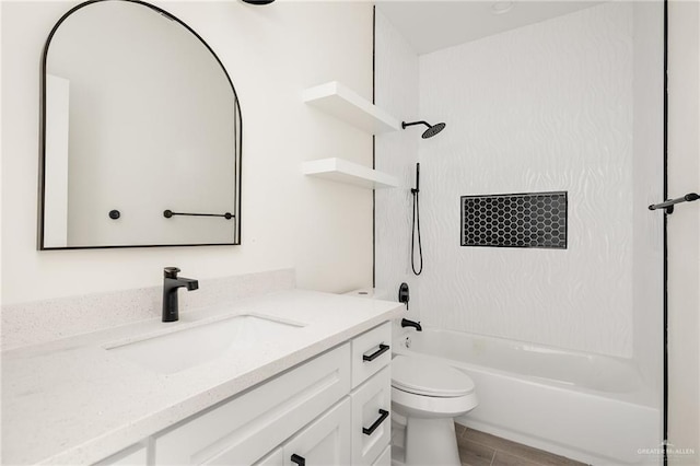 full bathroom with hardwood / wood-style flooring, vanity, toilet, and washtub / shower combination