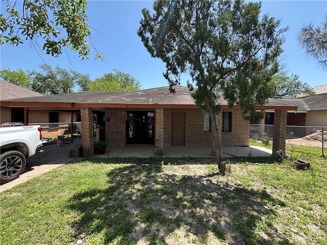 7221 S San Joaquin St, Pharr, TX 78577 - back of house with a yard, brick siding, a patio area, and fence