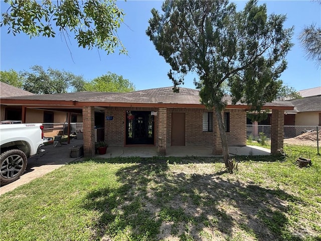 7221 S San Joaquin St, Pharr, TX 78577 - view of front of property with brick siding, a front yard, and fence