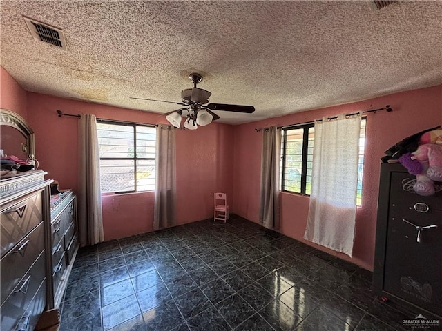 7221 S San Joaquin St, Pharr, TX 78577 - empty room with a textured ceiling, a healthy amount of sunlight, a ceiling fan, and visible vents