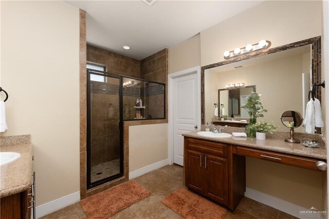 4230 Stillwater Cv, Edinburg, TX 78542 - full bathroom featuring tile patterned flooring, baseboards, vanity, and a stall shower