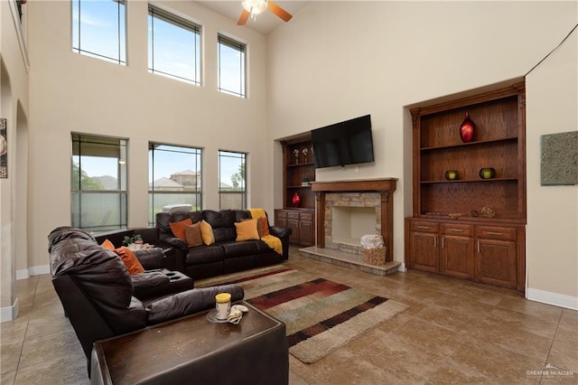 4230 Stillwater Cv, Edinburg, TX 78542 - living room featuring baseboards, a towering ceiling, built in features, ceiling fan, and a fireplace