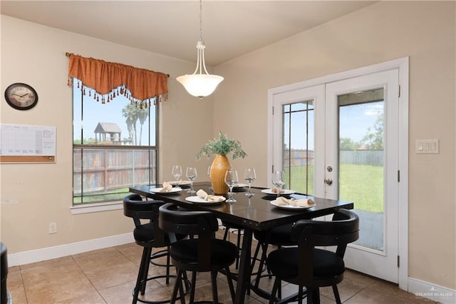 4230 Stillwater Cv, Edinburg, TX 78542 - dining area with light tile patterned floors, plenty of natural light, baseboards, and french doors