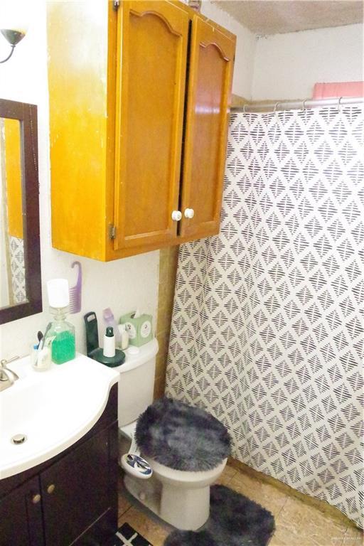 bathroom with vanity, tile patterned flooring, toilet, and a shower with shower curtain