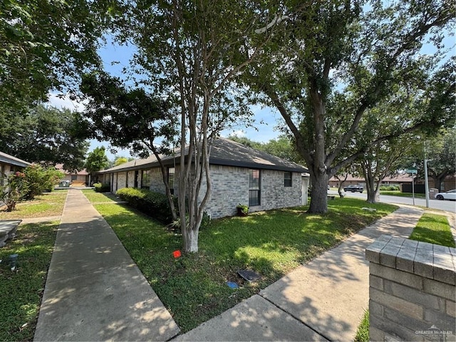 view of side of home featuring a lawn