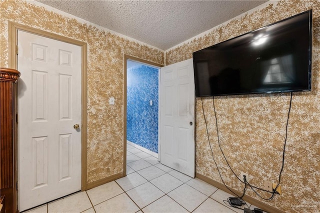 interior space with light tile patterned floors and a textured ceiling