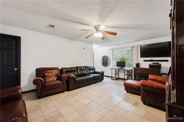 tiled living room featuring a textured ceiling and ceiling fan