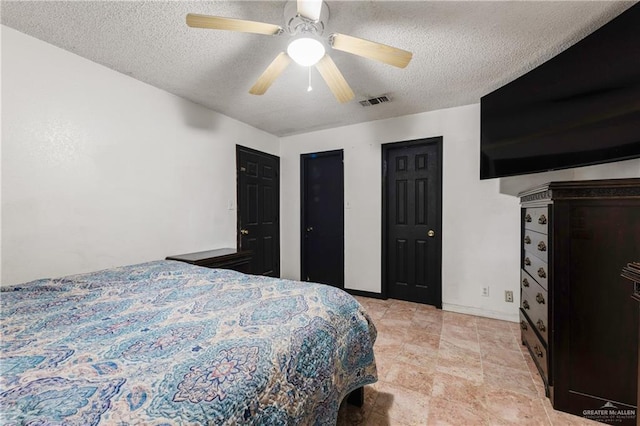 bedroom featuring a textured ceiling and ceiling fan