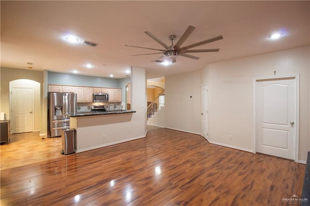 3109 Viola Dr, Mission, TX 78574 - kitchen with appliances with stainless steel finishes, arched walkways, ceiling fan, dark countertops, and open floor plan