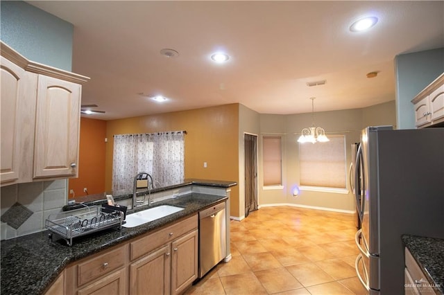 3109 Viola Dr, Mission, TX 78574 - kitchen with stainless steel appliances, a sink, a chandelier, recessed lighting, and dark stone countertops