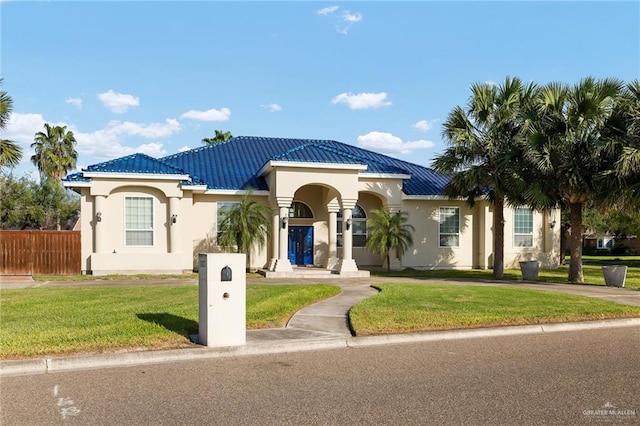 mediterranean / spanish home with a front yard