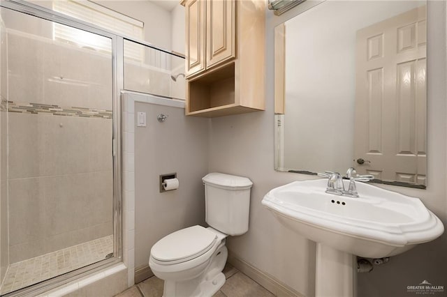 bathroom featuring sink, tile patterned flooring, a shower with shower door, and toilet