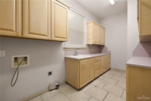 washroom featuring sink, washer hookup, cabinets, hookup for an electric dryer, and light tile patterned flooring