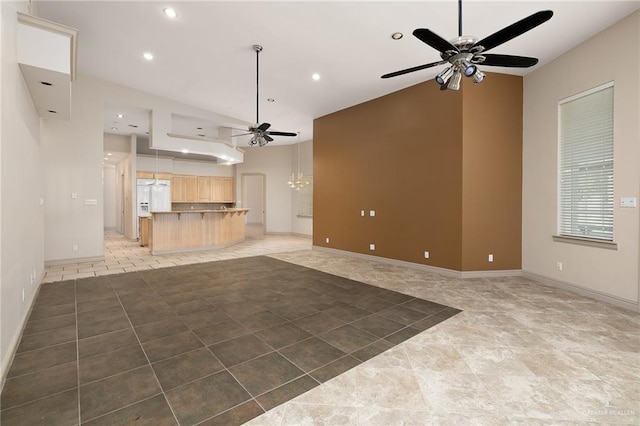 unfurnished living room featuring ceiling fan