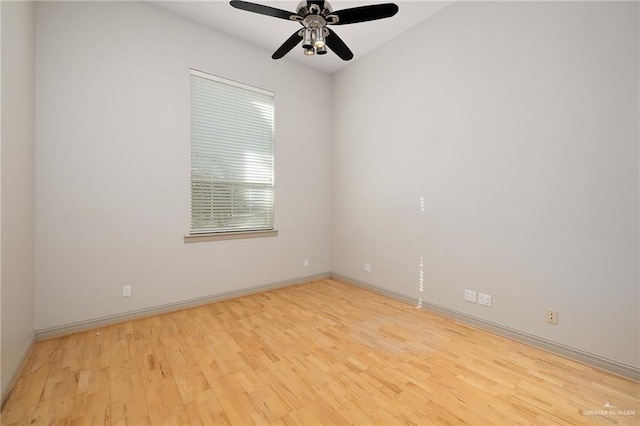 spare room with ceiling fan and light wood-type flooring