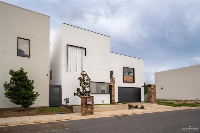 6706 N 11th Ln, Mcallen, TX 78504 - modern home featuring a garage, concrete driveway, and stucco siding
