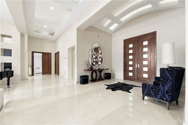 foyer with french doors and high vaulted ceiling