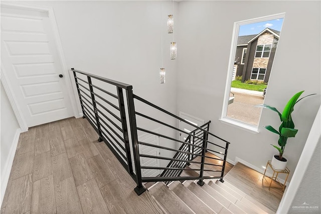 5516 N Crown Pt, Pharr, TX 78577 - unfurnished bedroom with wood finished floors, a tray ceiling, a closet, and baseboards