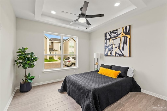 5516 N Crown Pt, Pharr, TX 78577 - bedroom with a tray ceiling, wood finish floors, baseboards, and recessed lighting