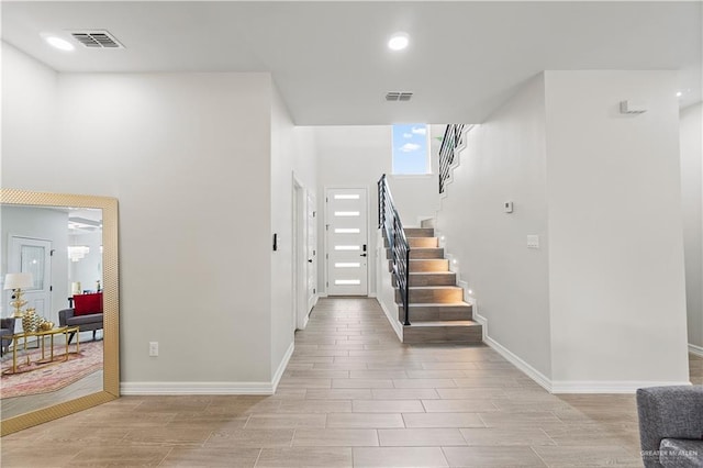 5516 N Crown Pt, Pharr, TX 78577 - foyer featuring wood tiled floors, stairway, and baseboards