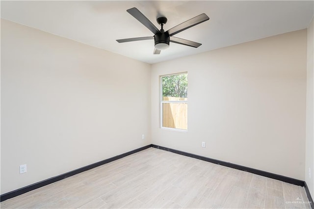 spare room with light wood-style floors, baseboards, and a ceiling fan