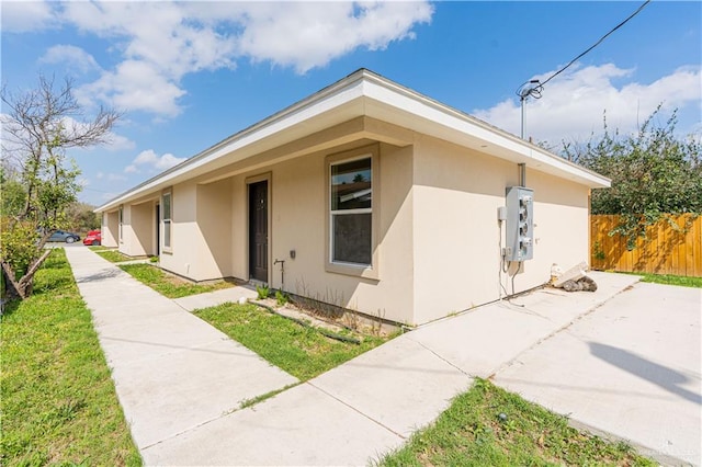 view of front of property featuring fence and stucco siding