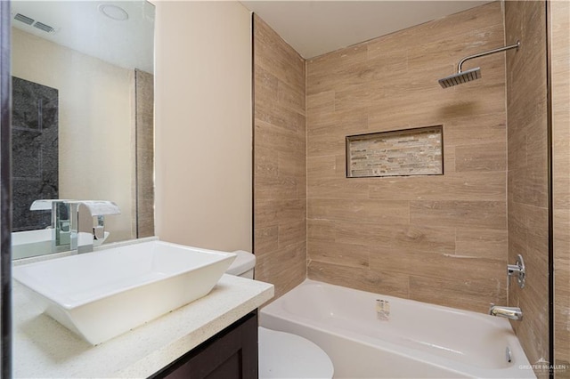 full bathroom with shower / bath combination, visible vents, vanity, and toilet