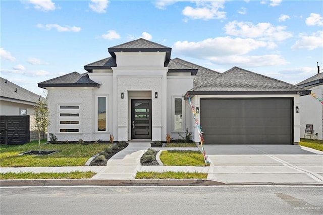 view of front of house featuring driveway, an attached garage, roof with shingles, and stucco siding