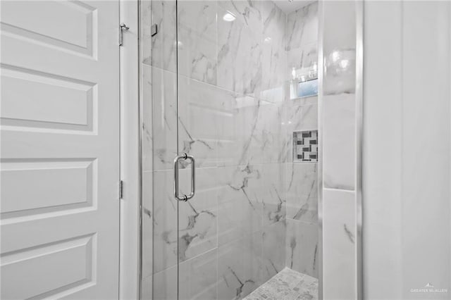 full bath with a marble finish shower