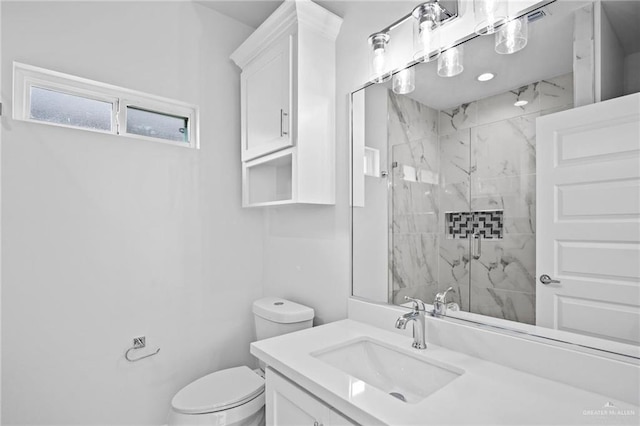 full bath with toilet, a marble finish shower, and vanity