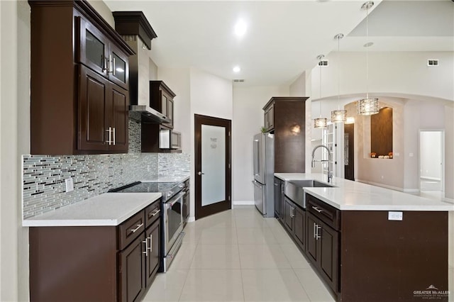5013 Nevis Dr, Edinburg, TX 78539 - kitchen with stainless steel appliances, dark brown cabinetry, backsplash, a peninsula, and recessed lighting