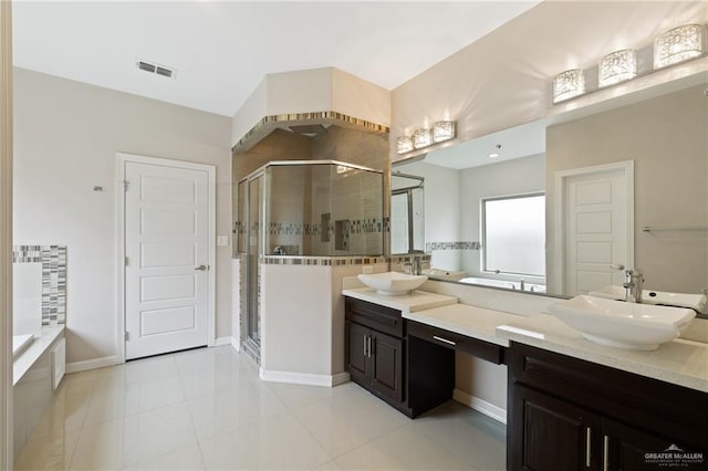 5013 Nevis Dr, Edinburg, TX 78539 - bathroom with double vanity, a stall shower, a bath, and tile patterned flooring