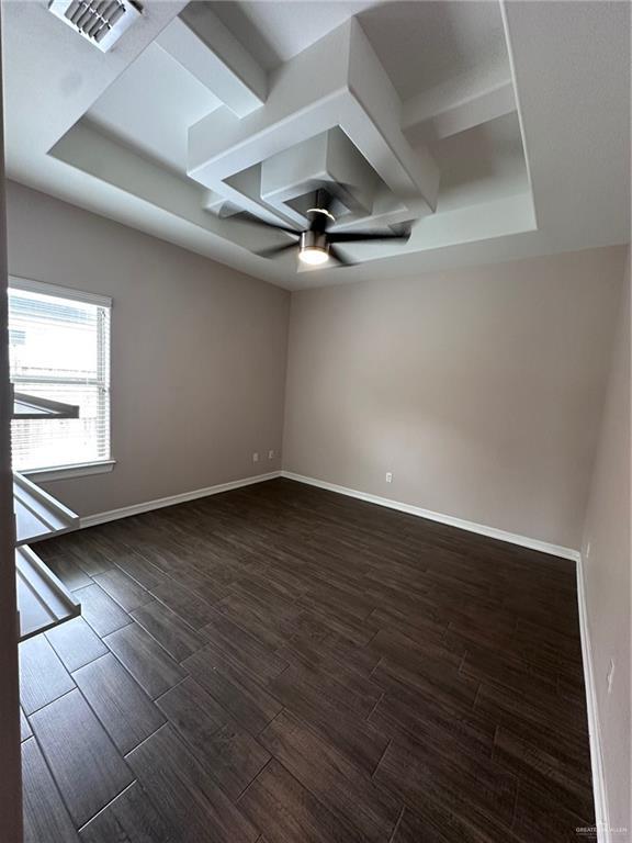 5013 Nevis Dr, Edinburg, TX 78539 - empty room with a ceiling fan, dark wood finished floors, baseboards, and a raised ceiling