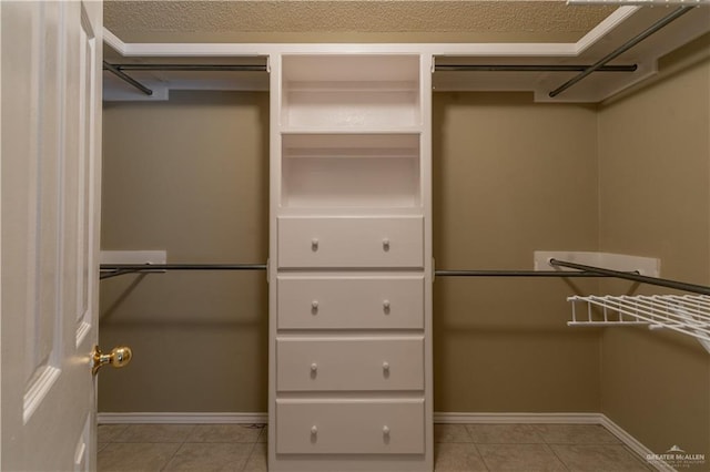 spacious closet featuring light tile patterned flooring