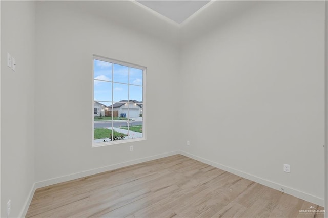 1007 Broken Arrow Dr, Alamo, TX 78516 - unfurnished room with baseboards, a healthy amount of sunlight, and light wood finished floors