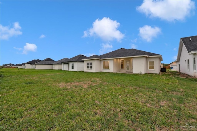 1007 Broken Arrow Dr, Alamo, TX 78516 - back of house featuring a lawn and stucco siding