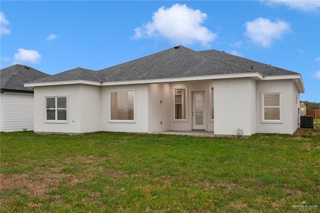 1007 Broken Arrow Dr, Alamo, TX 78516 - rear view of house with stucco siding, central AC unit, a yard, and a shingled roof