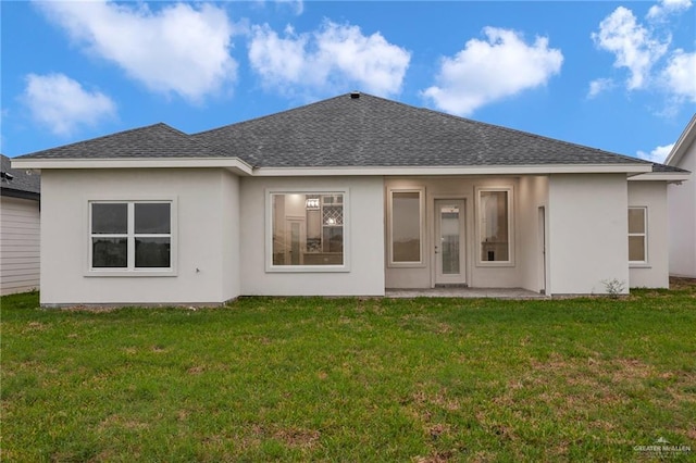 1007 Broken Arrow Dr, Alamo, TX 78516 - rear view of house featuring a lawn, a shingled roof, and stucco siding