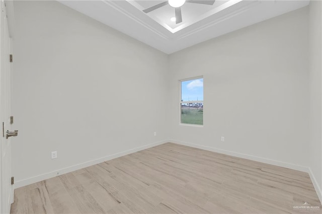 1007 Broken Arrow Dr, Alamo, TX 78516 - unfurnished room featuring a ceiling fan, baseboards, a tray ceiling, and light wood-type flooring