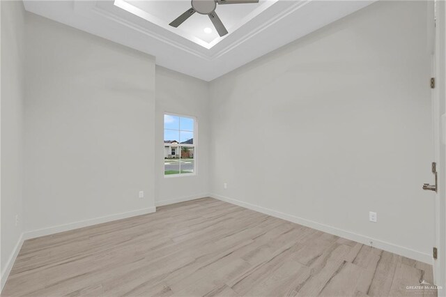 1007 Broken Arrow Dr, Alamo, TX 78516 - empty room featuring baseboards, a raised ceiling, and light wood finished floors