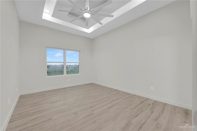 1007 Broken Arrow Dr, Alamo, TX 78516 - spare room with a ceiling fan, baseboards, a raised ceiling, and light wood-style floors
