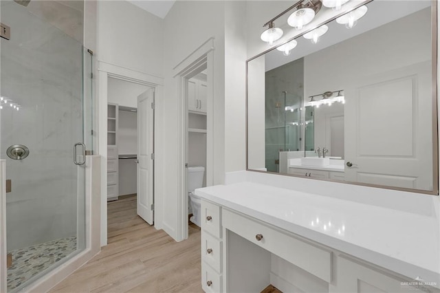1007 Broken Arrow Dr, Alamo, TX 78516 - full bath with toilet, a stall shower, wood finished floors, and a spacious closet