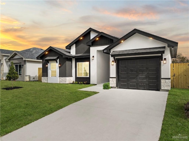 view of front of house featuring a yard and a garage