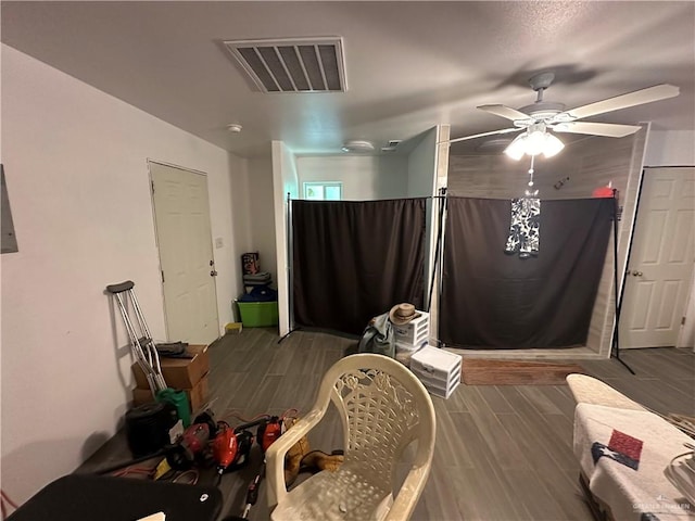 bedroom with ceiling fan and wood-type flooring