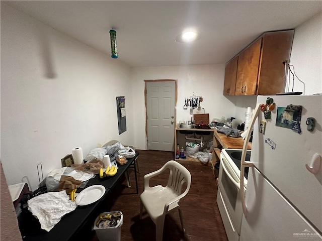 kitchen with dark hardwood / wood-style flooring and white appliances