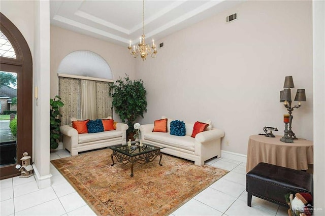 tiled living room with a raised ceiling and a notable chandelier