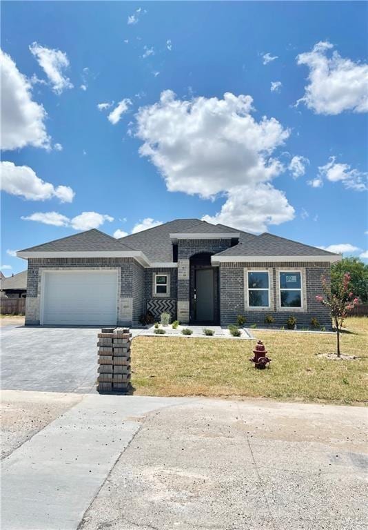 view of front of house with a garage and a front lawn