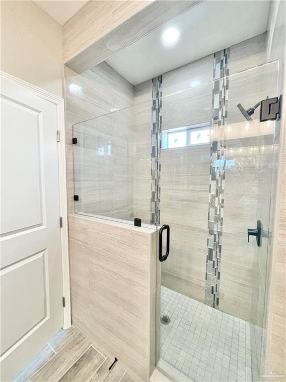 bathroom with a shower with shower door