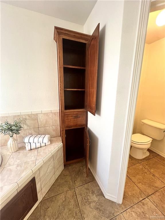 bathroom with tile patterned flooring and toilet