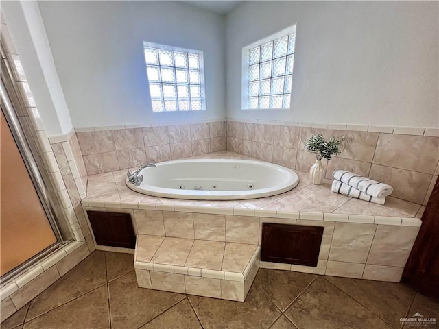 bathroom with plus walk in shower and tile patterned flooring